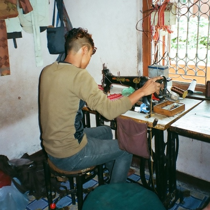 Artisan working on leather products with precision